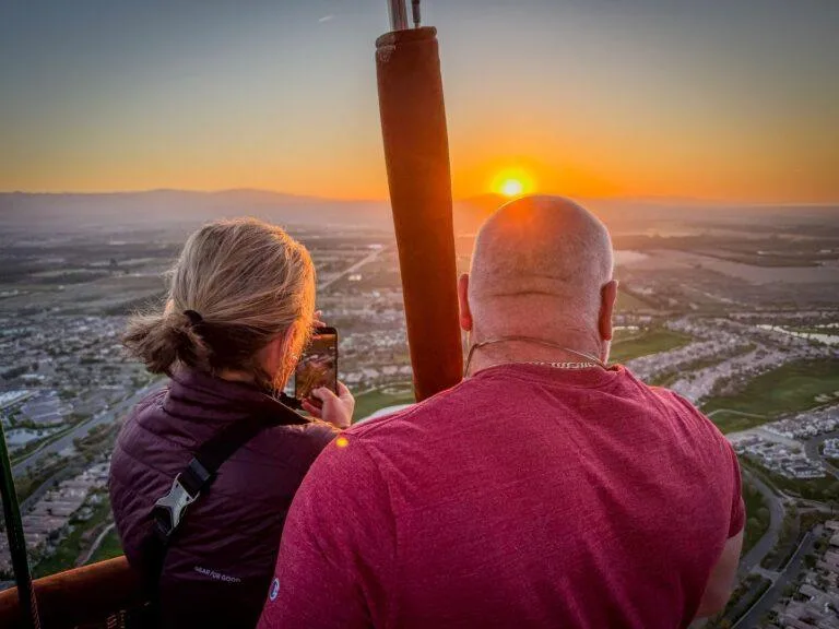 Couple watching the sunrise from a hot air balloon over Nashville